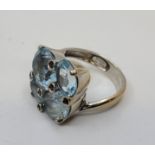 A Criso 18ct white gold, light blue topaz and purple gem stone cluster ring, claw set four mixed