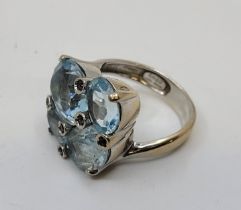 A Criso 18ct white gold, light blue topaz and purple gem stone cluster ring, claw set four mixed