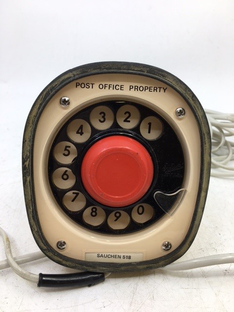 A vintage white telephone.