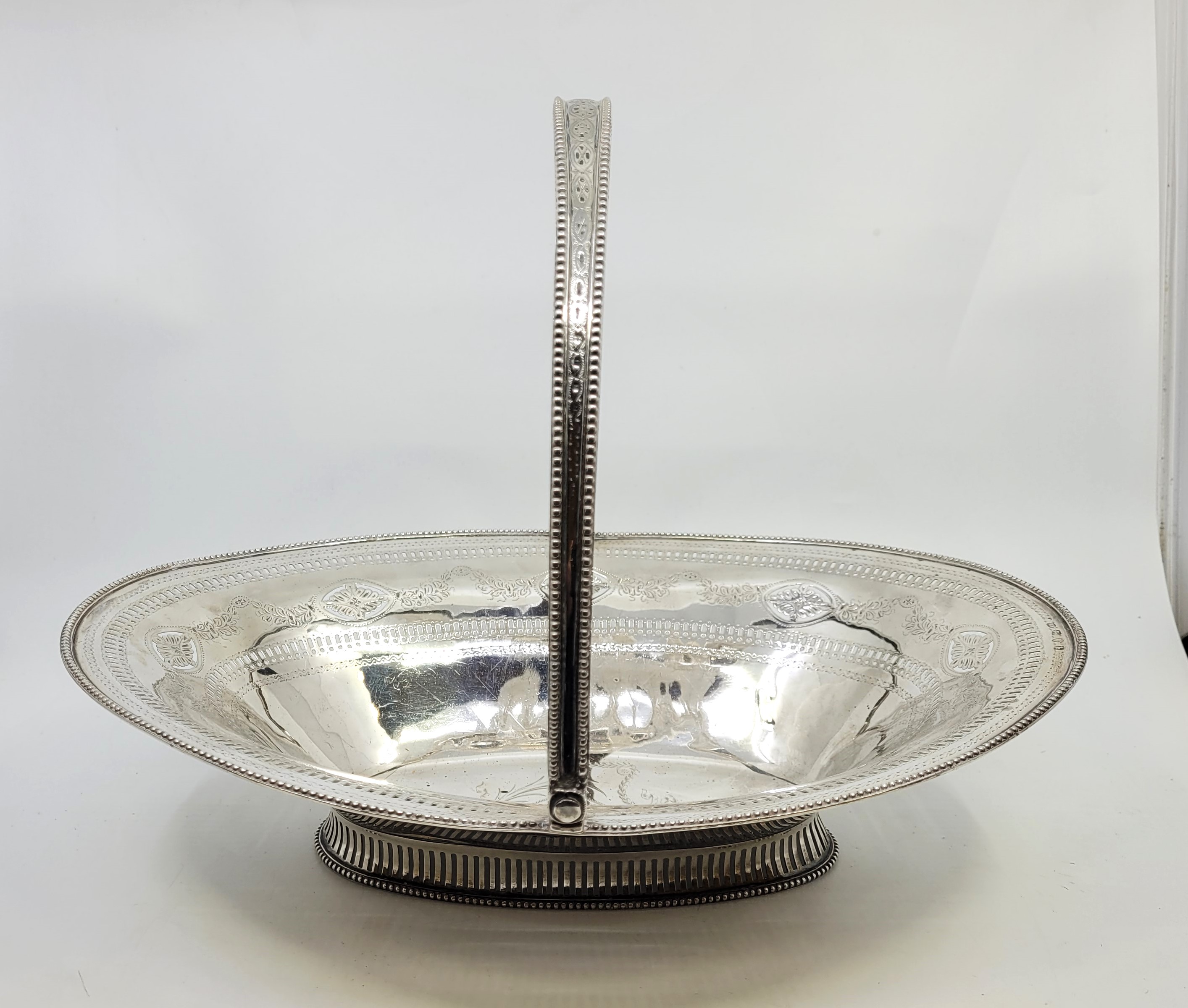 A George III silver swing handled basket, Robert Hennell I, London 1793, of ovoid form, the out