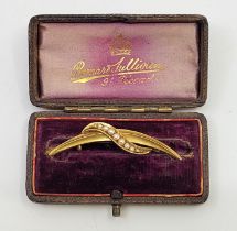 A Victorian 15ct. gold and seed pearl brooch, Chester 1895, of scroll and crescent form set