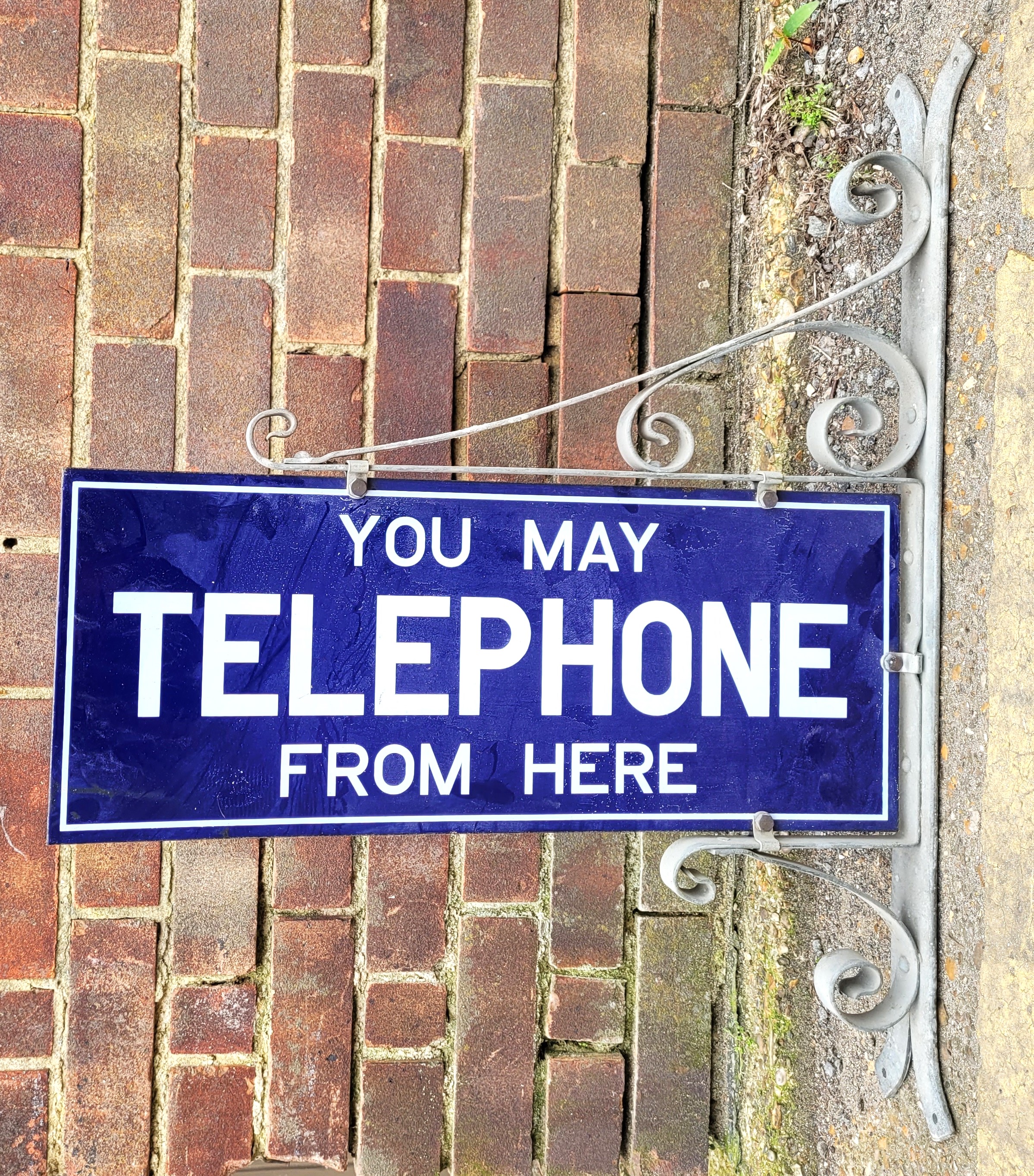 "You May Telephone From Here", an original double sided enamelled sign, 23cm x 55.8cm, with