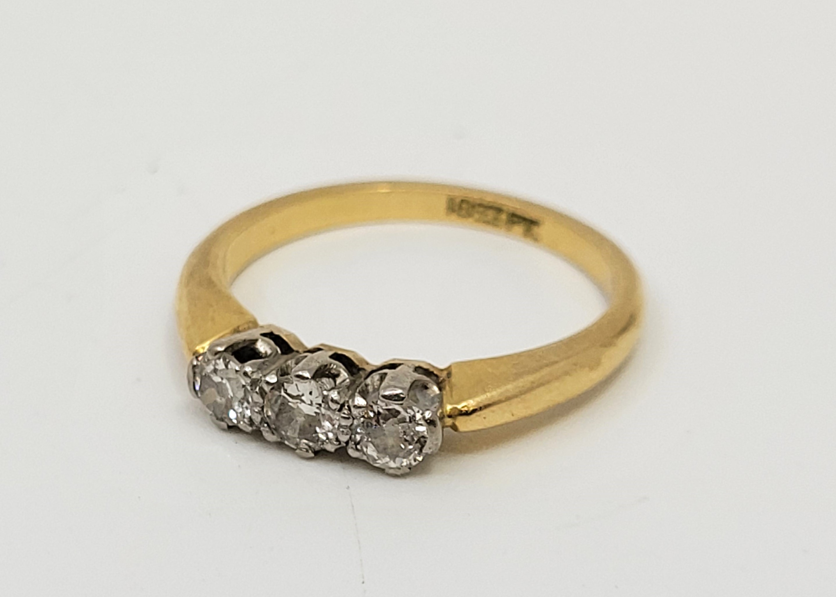 An 18ct. gold and platinum three stone diamond ring, set three round brilliant cut diamonds (ETDW - Image 7 of 9