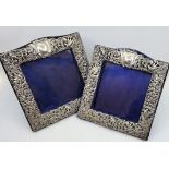 A pair of silver easel back photograph frames, by Henry Mathews, Birmingham 1901, repousse scrolling