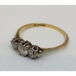 A precious yellow metal and platinum three stone diamond ring, set three graduated old cut