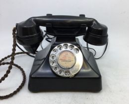 A vintage black bell telephone.