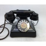 A vintage black bell telephone.