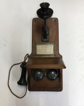 An early 20th cent oak wall mounted telephone