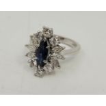 An 18ct. white gold, platinum, sapphire and diamond ring, set marquise cut blue sapphire to centre