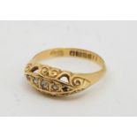 An 18ct. gold five stone diamond ring, Birmingham 1918, set three graduated eight-cut diamonds to