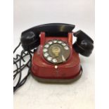 A vintage red bell telephone (a/f)