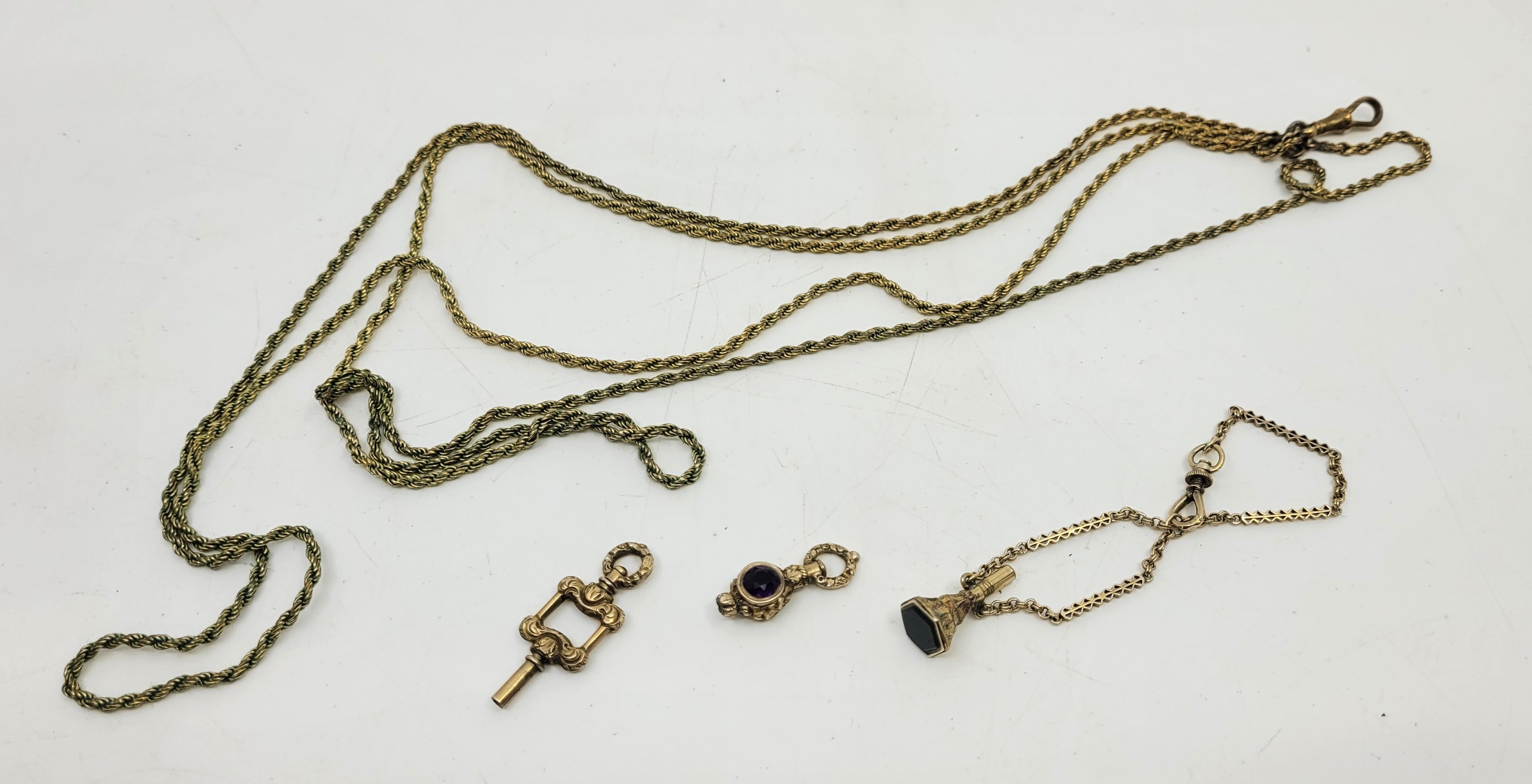 A yellow metal fancy link chain, suspending a gilt metal and black onyx set seal/watch key, together - Image 2 of 3