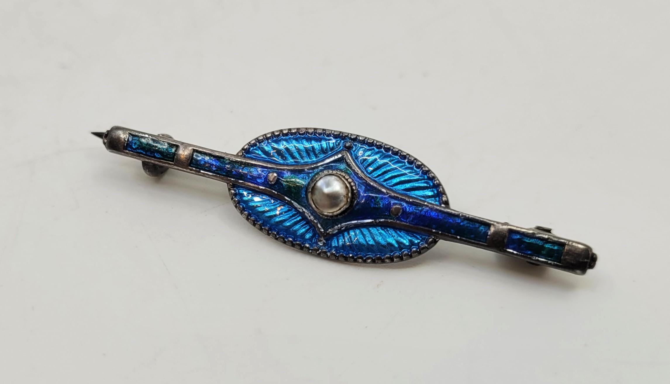 A Charles Horner silver, blue guilloche enamel and seed pearl bar brooch, Chester 1911, length