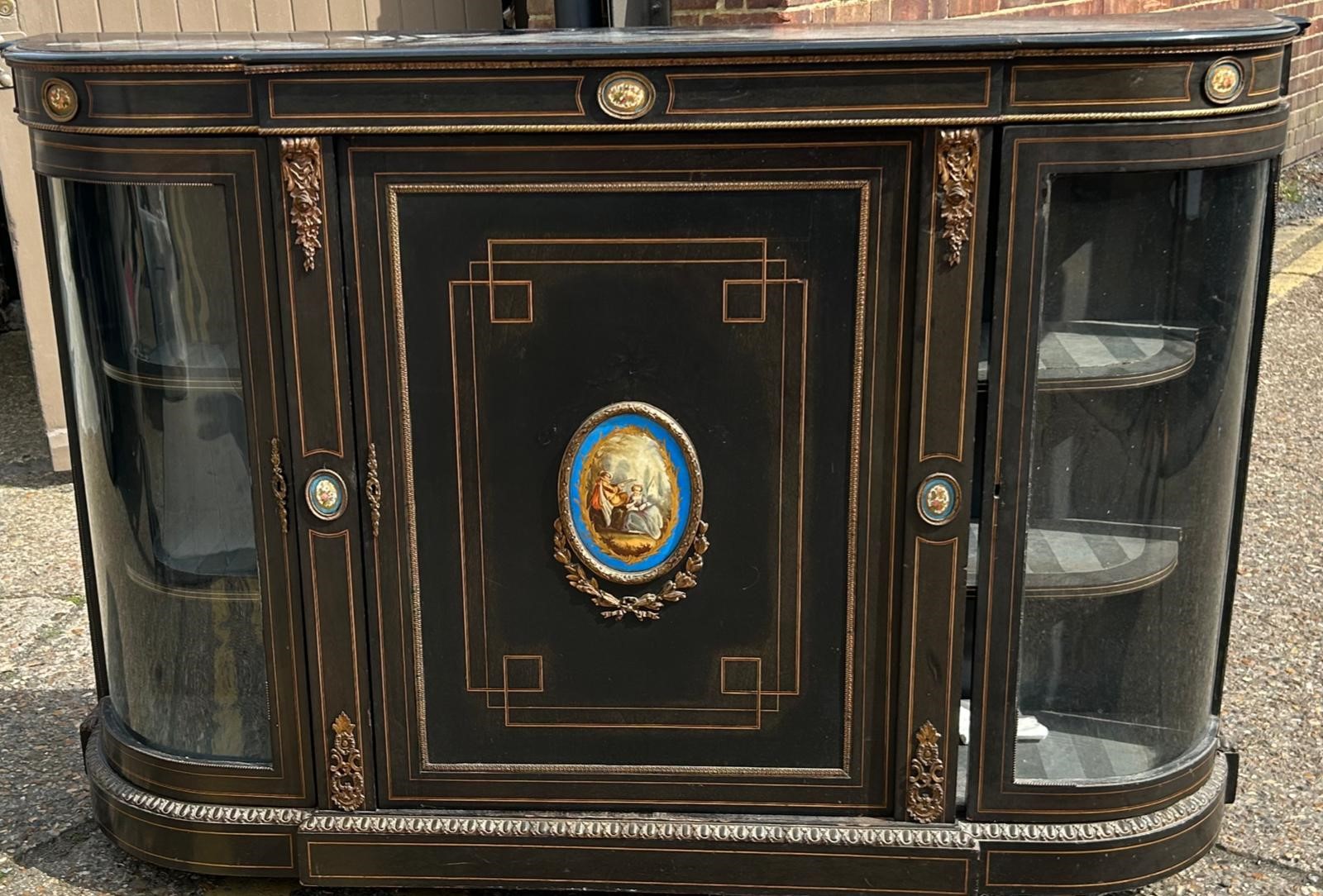 A 19th cent ebonised Credenza with Gilt ormolu mounted Sevres style panels , retaining original key