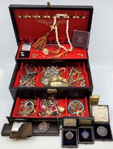 A collection of costume jewellery, to include: a shooting medal dated 1910, stored in a jewellery