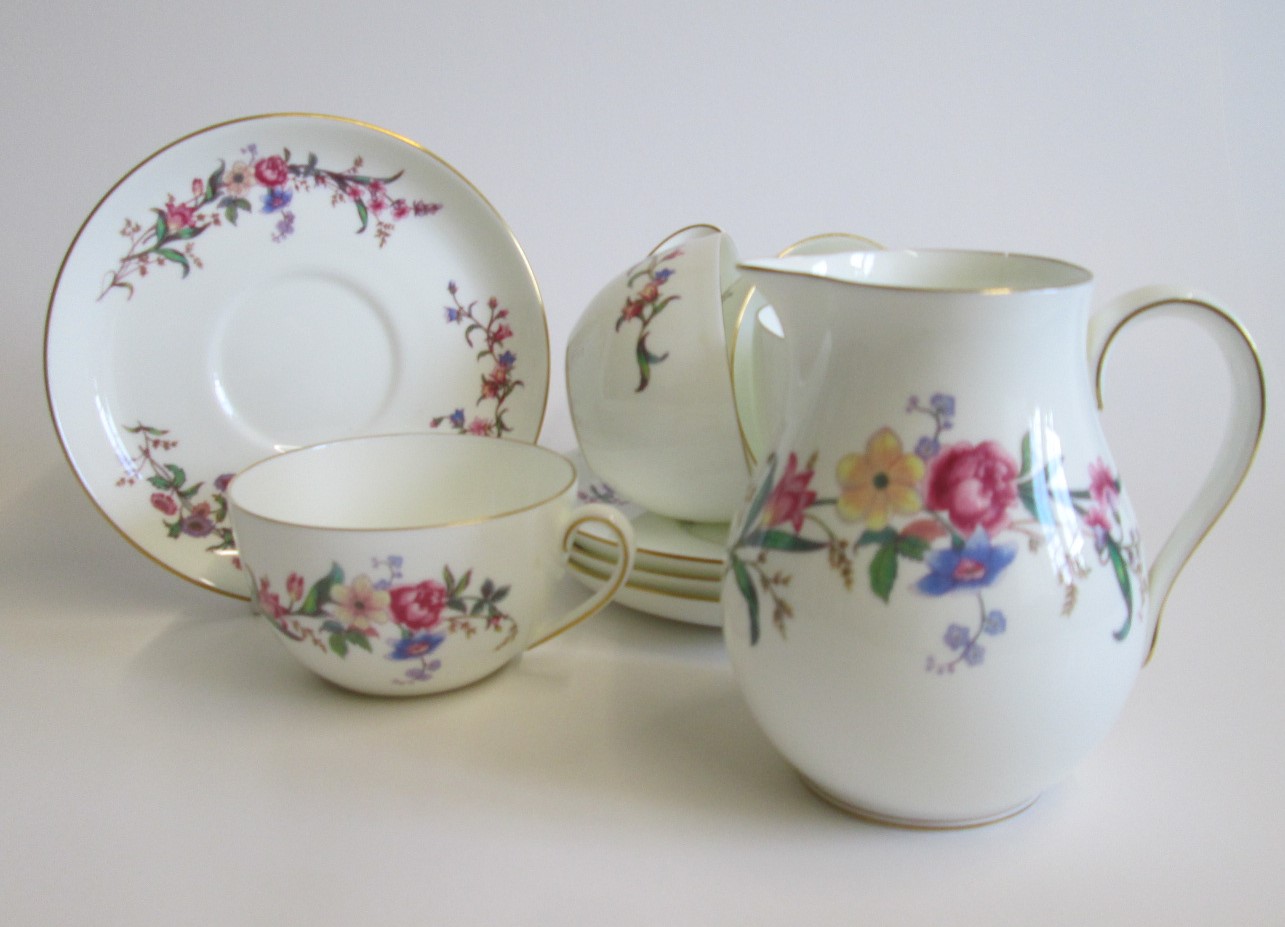 Four Wedgwood Bone China Breakfast Cups and Saucers along with a Milk Jug  decorated with floral