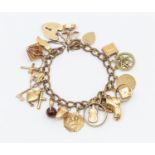 An unmarked 9ct gold charm bracelet, width approx 6mm,  length approx 190mm, testing as 9ct gold,