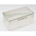A large George V plain silver cigarette box of slightly domed form, interior cover gilt with twin
