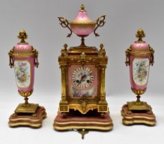 A mid 19th Century French bronze porcelain plague 8 day mantle clock with pink and gilt porcelain