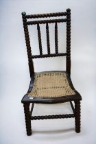 A b19th Century old country kitchen spindle back armchair, a 19th Century mahogany rocking chair and