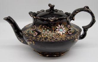 A black glazed vase, pot and cover and a teapot and cover, decorated with enamel and gilding, 19th