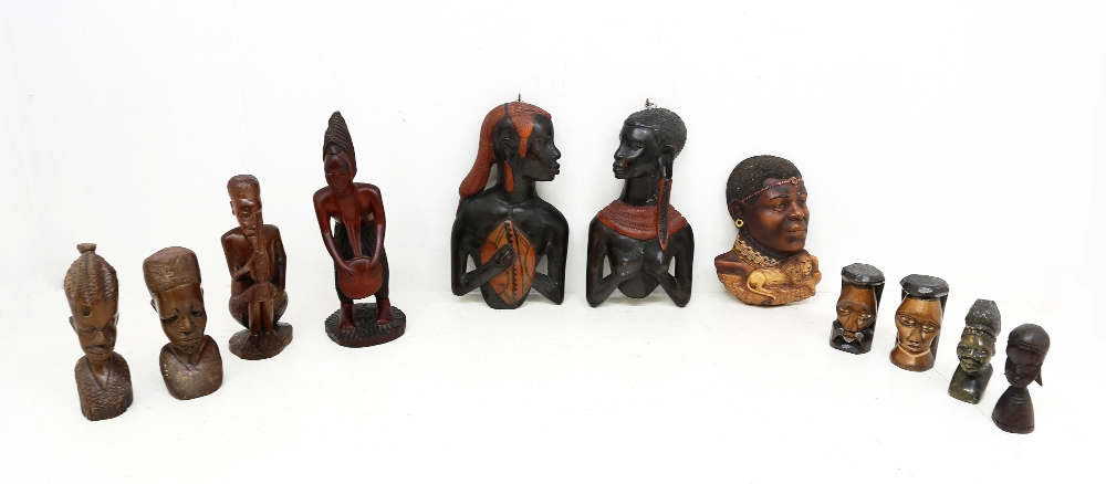 A collection of carved wooden African figures and heads.