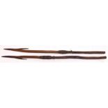 Two Aboriginal wooden spears, both with barbed sections, and bound with sinew. Carved with chevron