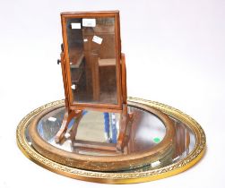 A mid 20th Century oval wall mirror, a 19th Century oval wall mirror and a 19th Century swing toilet