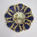 An English porcelain dish possibly Coalport decorated with country scene with a Cathedral with