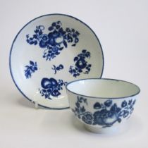 A Worcester tea bowl and saucer, underglaze blue with fruit sprigs Circa 1775 Tea bowl diameter 8cm,