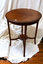 An Edwardian mahogany circular table on four feet with cross stretcher and circular stand