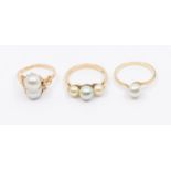 Three pearl set rings, to include a 14ct gold single grey coloured double pearl set ring, size N,
