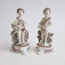 A pair of English porcelain   Cherubs ,probably spring, with flowers and autumn, with berries Circa;