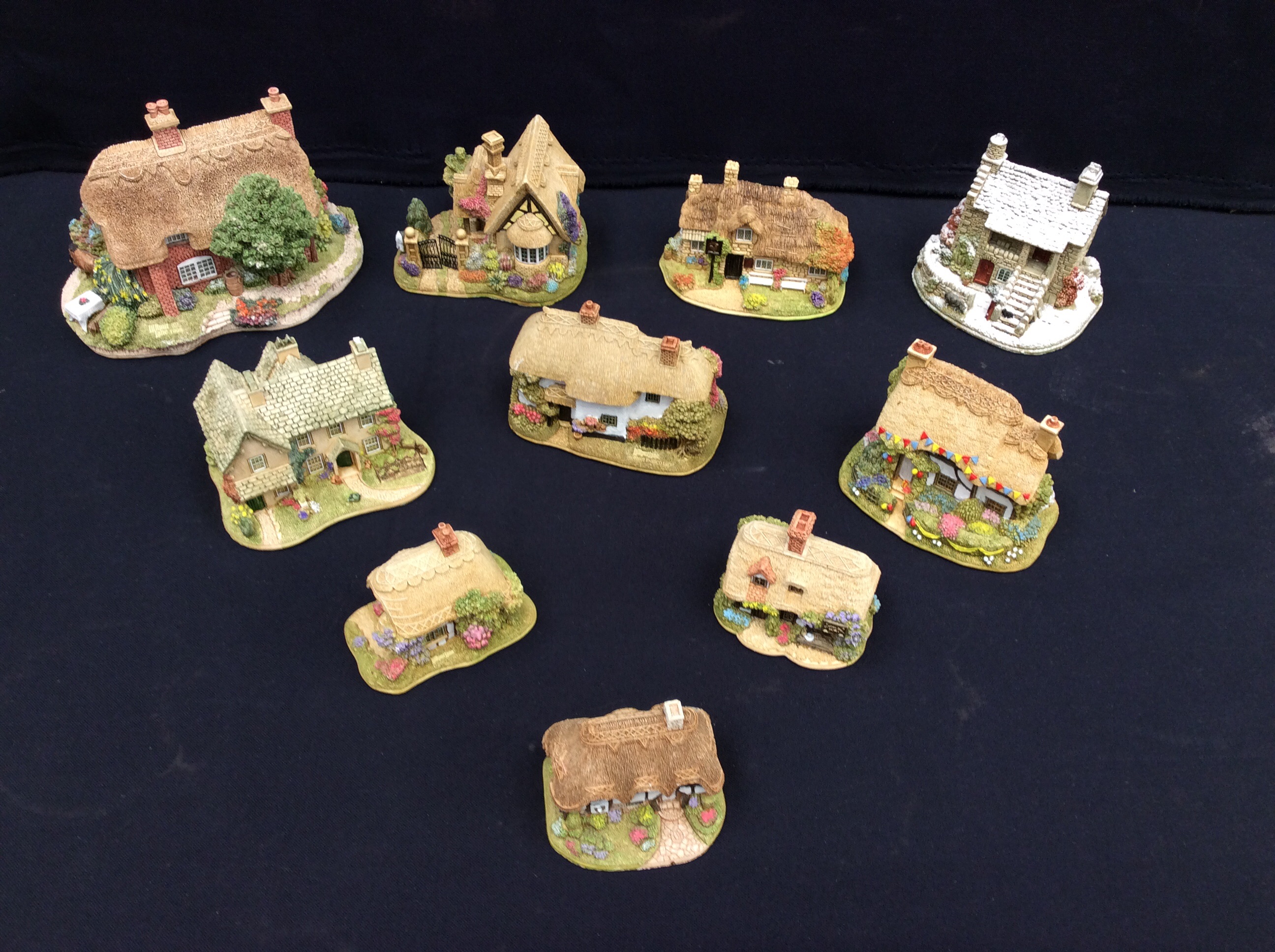 A collection of Lilliput Lane unboxed figures.