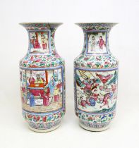 A pair of large late 19th century Cantonese famille rose baluster vases, decorated in bright enamels