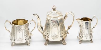 A Victorian Gothic style three piece tea set consisting of tea pot, milk jug and a twin handled
