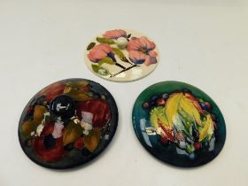 A Moorcroft Leaf & Berry powder bowl cover c1935 together with a Pomegranate powder bowl cover