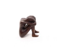 A small contemporary unsigned bronze of a nude lady curled up, approx. 6.5cm high.