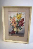 William E Powell (1878-1955): a signed watercolour of a vase filled with hollyhocks in oranges, reds