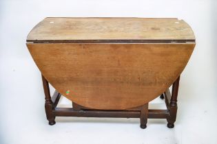 An 18th Century English oak drop leaf table/gate leg table with peg joints.