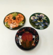 A Moorcroft Pomegranate Ginger Jar Lid c1920 together with a Moorcroft Orchid powder bowl cover