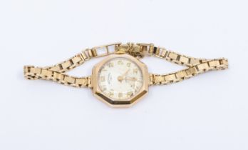A ladies vintage 9ct gold early 20th century wristwatch, comprising a round silvered dial with