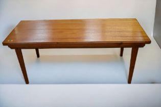 A mid 20th Century teak coffee table along with a mid 20th Century oak chair.