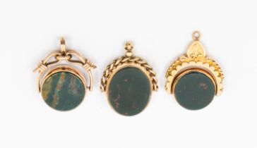 A collection of three 9ct gold hardstone swivel fobs, including two early 20th century and a later