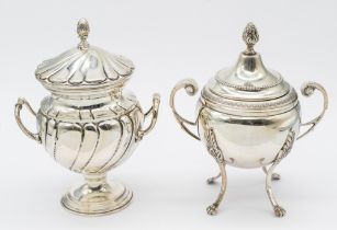 A Continental silver twin handled urn and cover, on four curved legs leading to paw feet, ornate