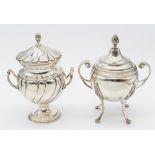 A Continental silver twin handled urn and cover, on four curved legs leading to paw feet, ornate