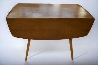 A mid 20th Century Ercol light oak dropleaf kitchen/dining table.