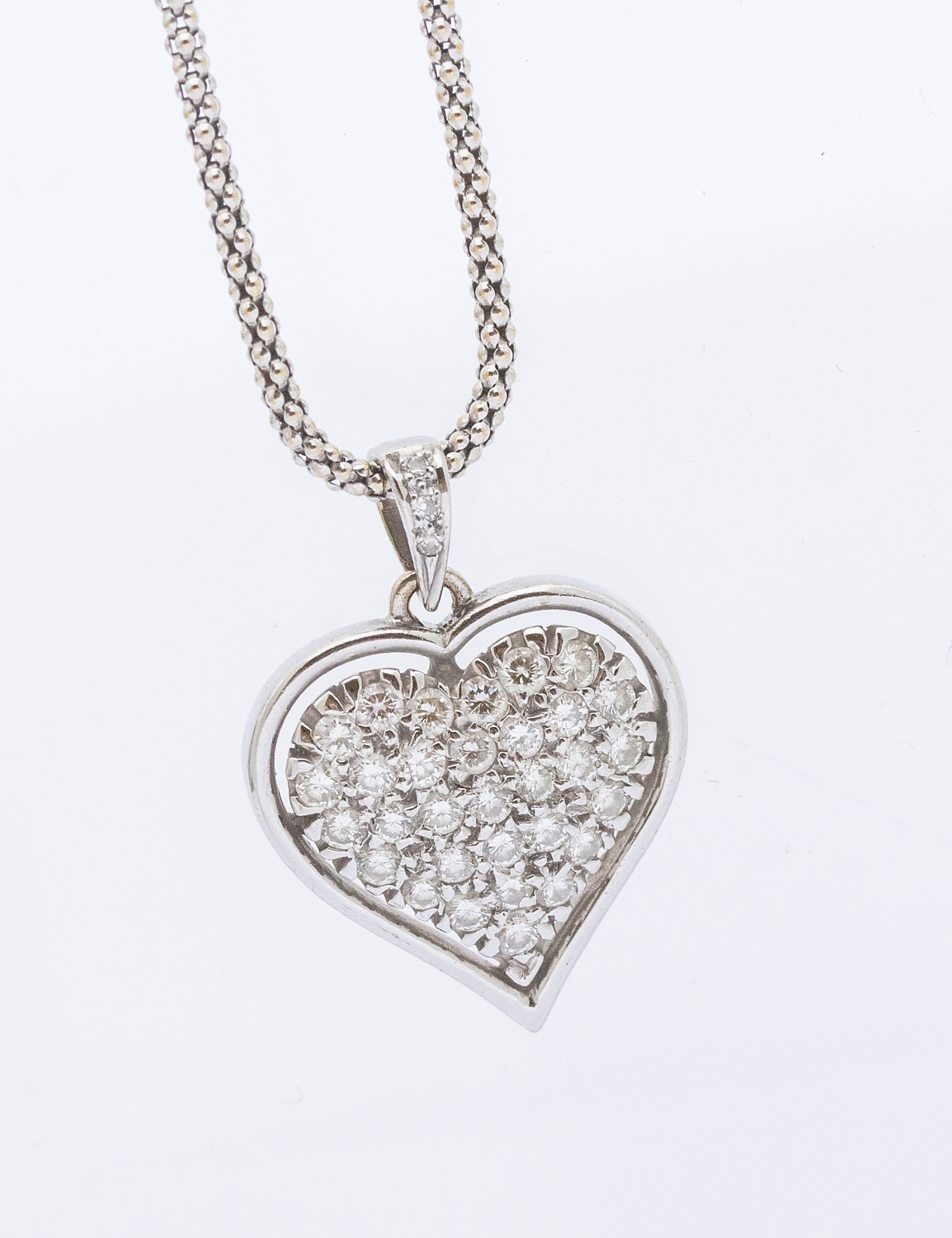 A diamond set 18ct white gold heart pendant, pave set with round brilliant cut diamonds, size approx