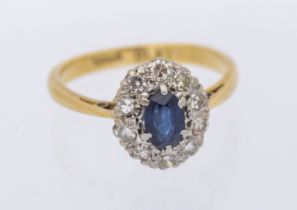 A single stone sapphire and diamond 18ctv gold oval cluster, setting approx 8x10mm, J, total gross