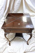 An Edwardian envelope card table in mahogany with green velvet playing surface and concave counter